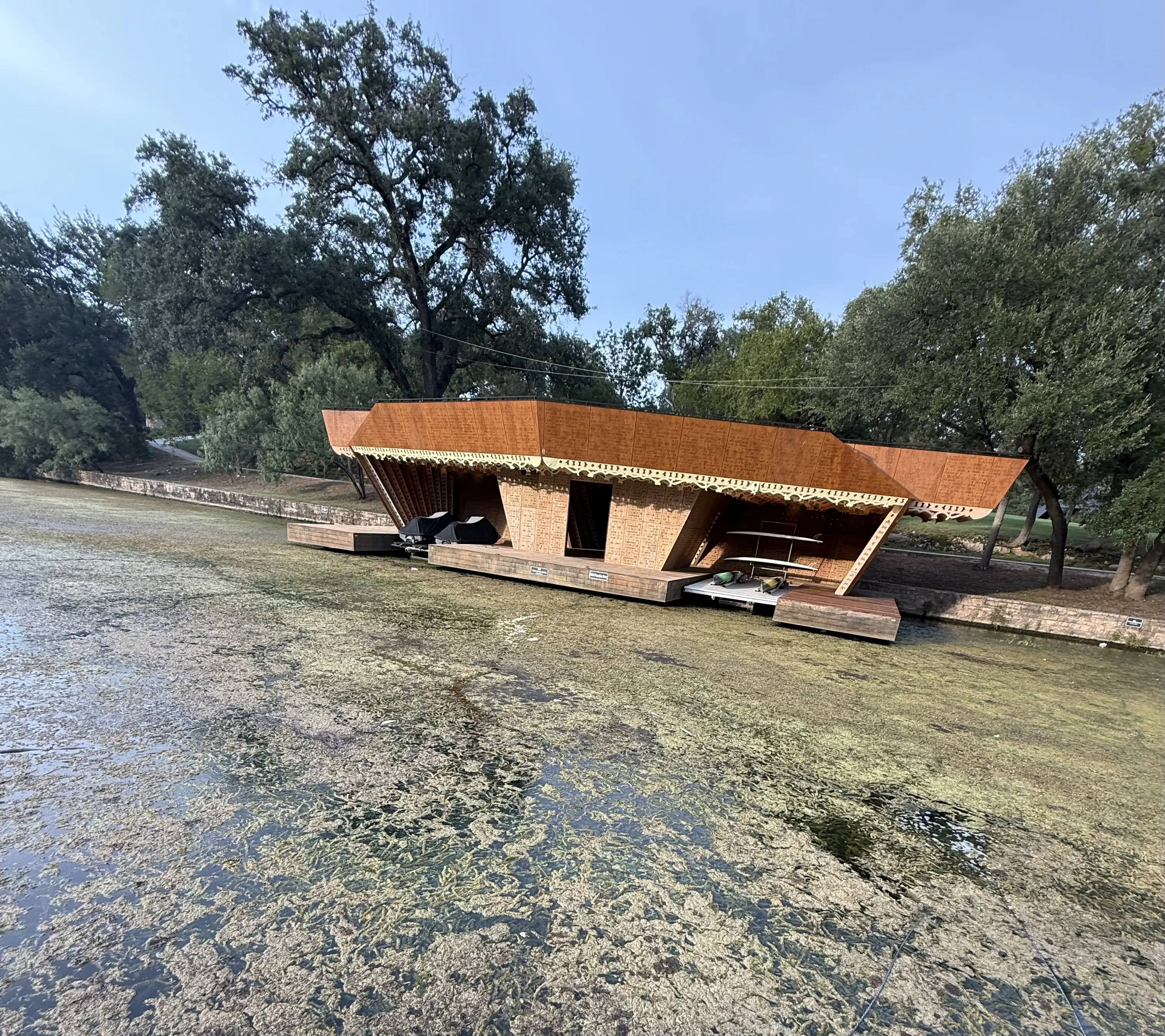 Lake Austin dock surrounded by dense hydrilla infestation before professional removal