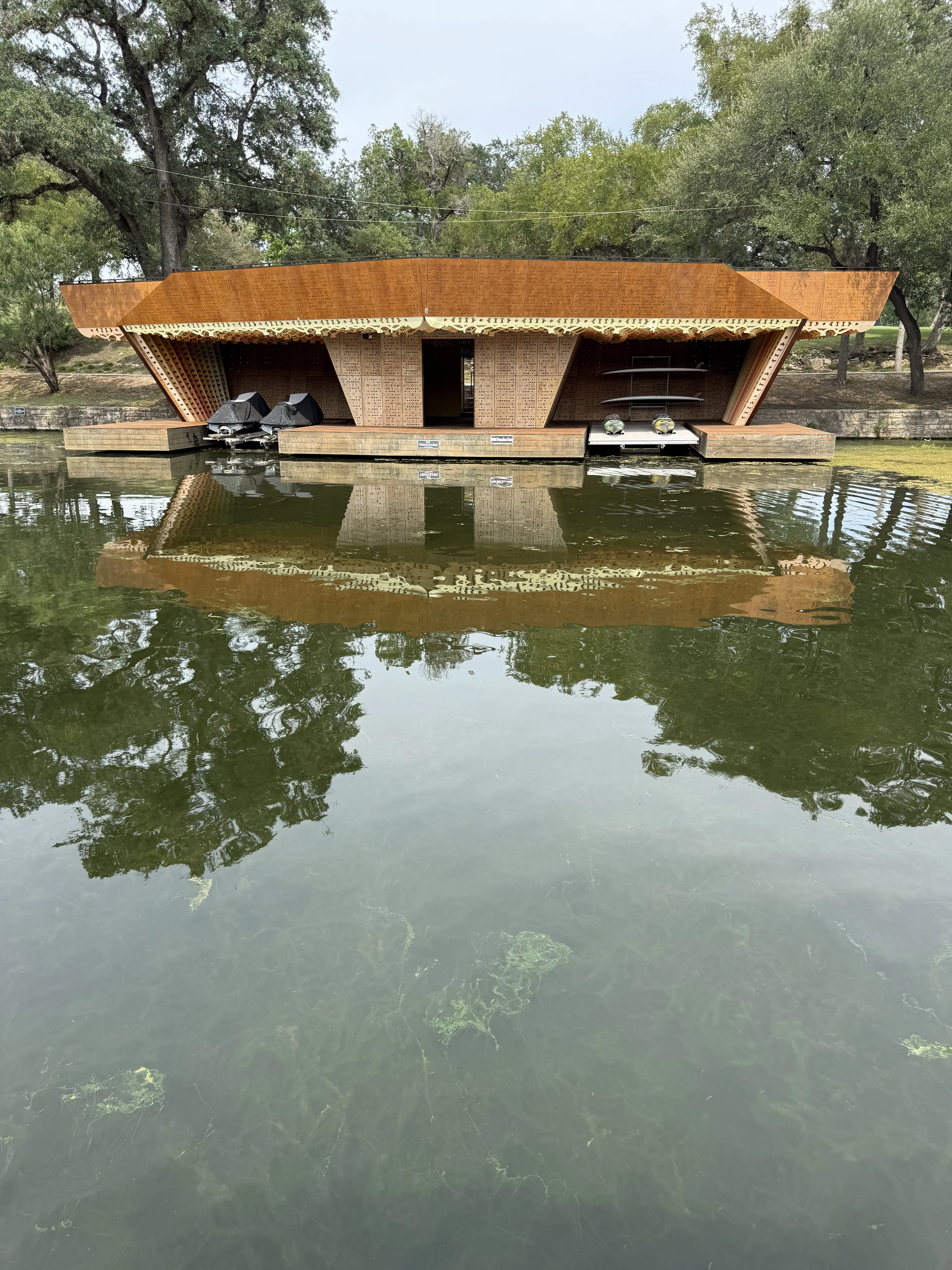 Lake Austin dock with clear water after professional hydrilla removal by Captain Home Services