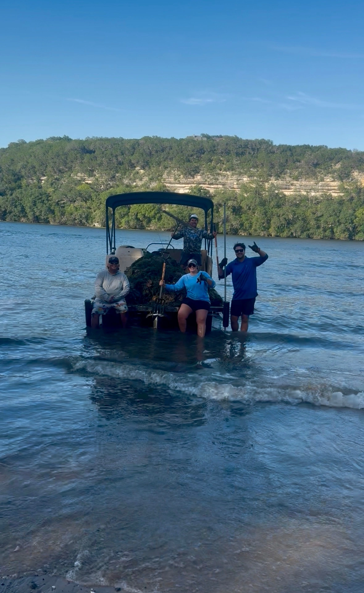 Lake weed removal specialist working on Lake Austin removing hydrilla by hand